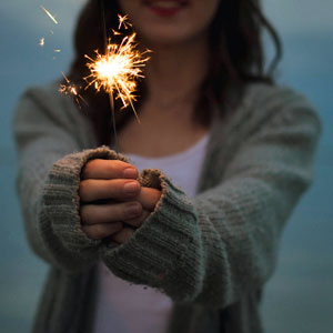 Young woman with sparkler