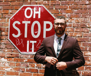 Man-standing-in-front-of-stop-sign
