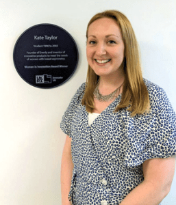 Kate-Taylor-founder-of-Evenly-with-Purple-Plaque