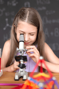 Girl looking into microscope