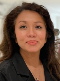 Christina Vaughan, Founder and CEO of Cultura Creative. Christina is smiling. She has long dark hair and is wearing a black jacket.